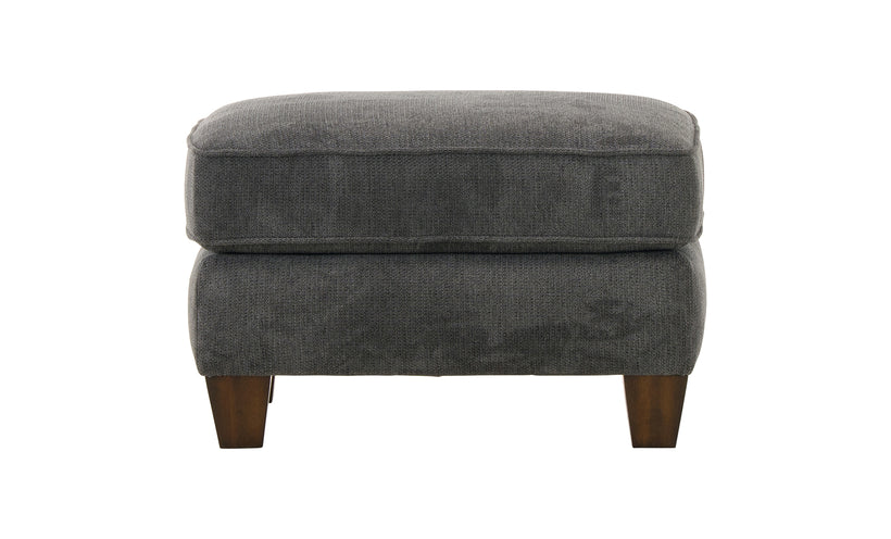 Gray upholstered ottoman with wooden legs on a white background